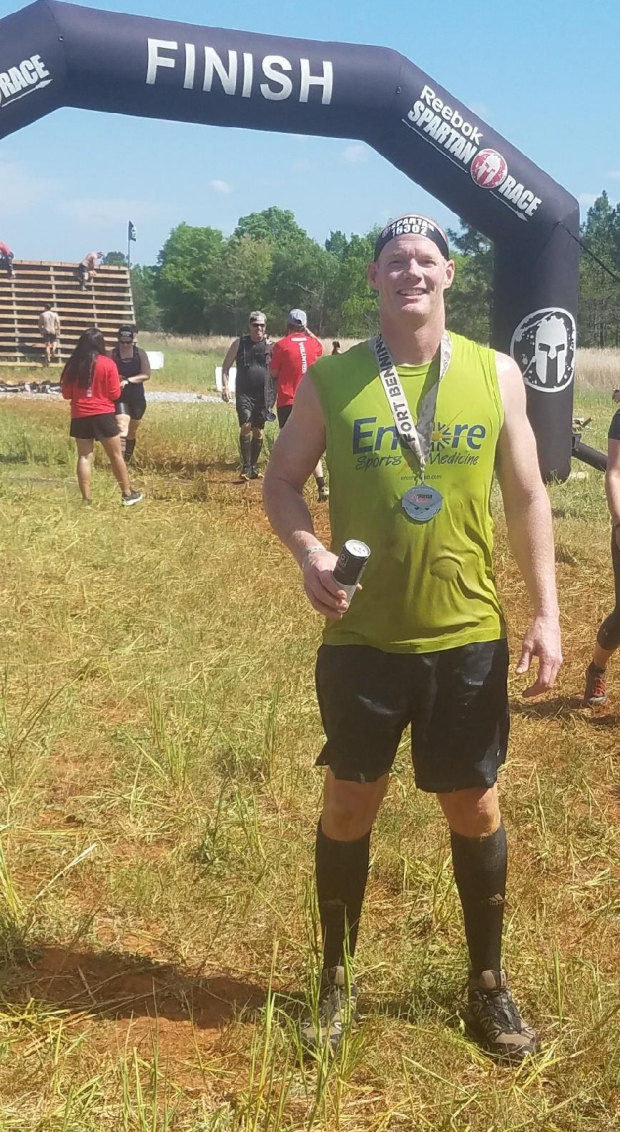 Runner smelling after completing Spartan Challenge Race, Fort Benning, Georgia