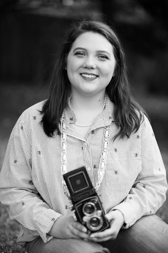 black and white photos of a smiling teenaged girl holding a brownie camera